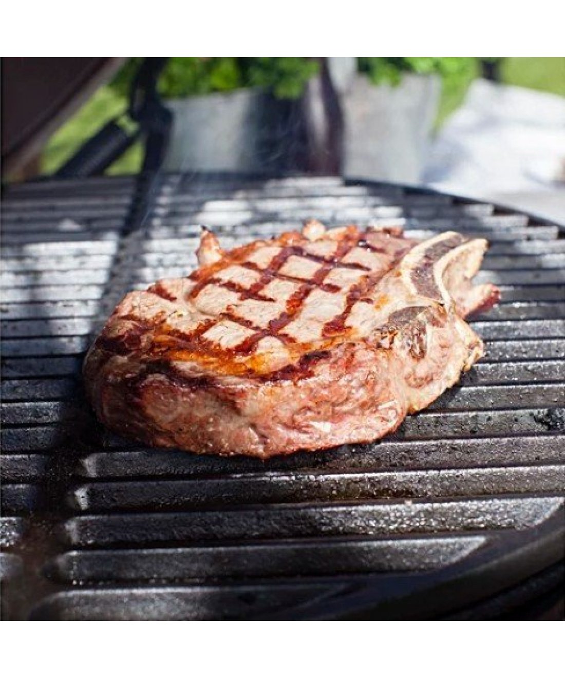 Famous Garden UK steak cooking on cast iron cooking grid
